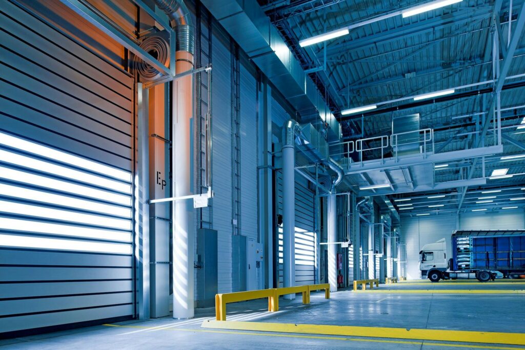 pexels-photo-209251-209251 Spacious and modern warehouse interior with parked truck and steel structures.